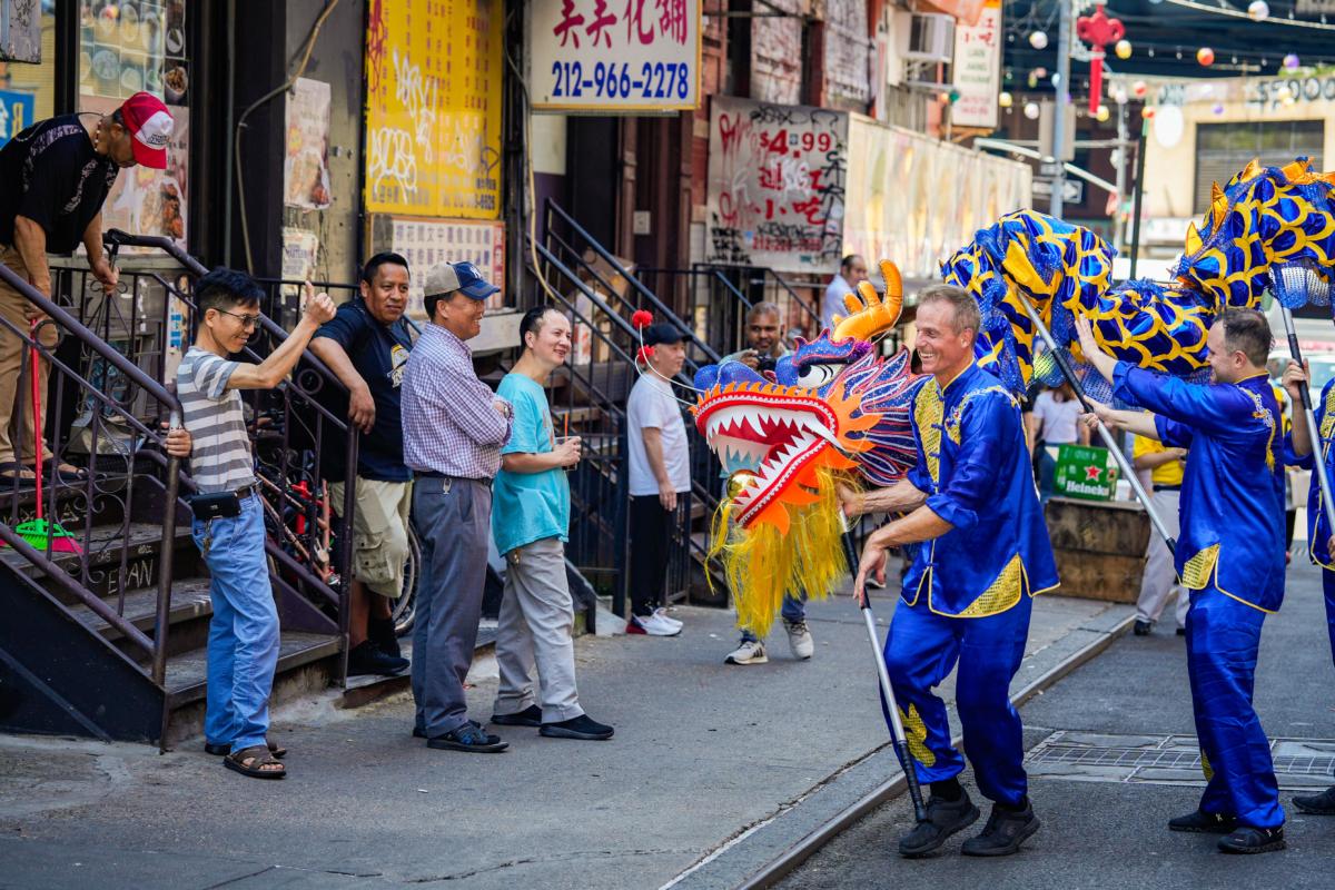 Falun Gong practitioners take part in a parade to commemorate the 24th anniversary of the persecution of the spiritual discipline in China, in New York's Chinatown on July 15, 2023. (Samira Bouaou/The Epoch Times)