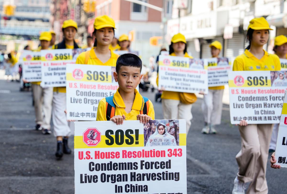 Falun Gong practitioners take part in a parade to commemorate the 24th anniversary of the persecution of the spiritual discipline in China, in New York's Chinatown on July 15, 2023. (Samira Bouaou/The Epoch Times)