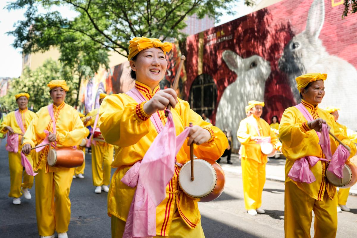 Falun Gong practitioners take part in a parade to commemorate the 24th anniversary of the persecution of the spiritual discipline in China, in New York's Chinatown on July 15, 2023. (Samira Bouaou/The Epoch Times)