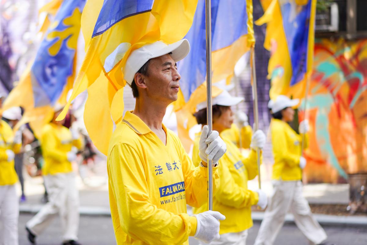 Falun Gong practitioners take part in a parade to commemorate the 24th anniversary of the persecution of the spiritual discipline in China, in New York's Chinatown on July 15, 2023. (Samira Bouaou/The Epoch Times)