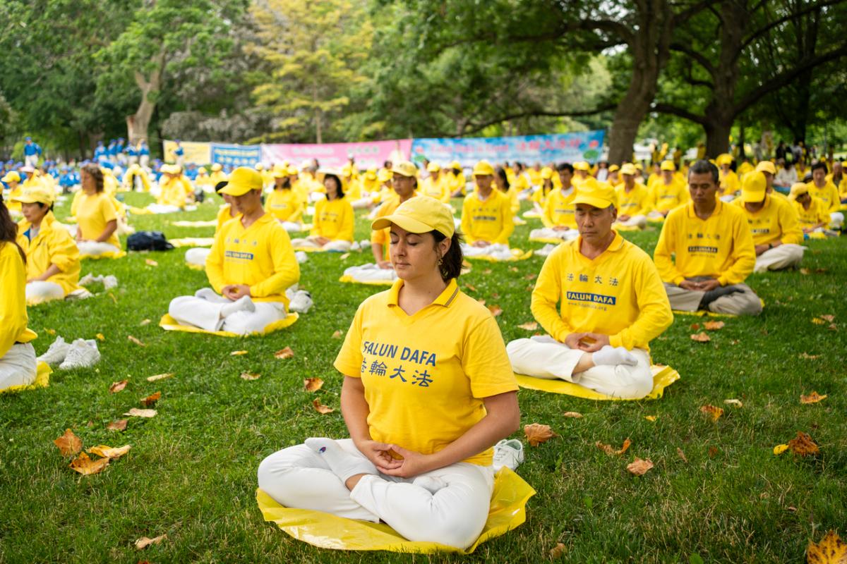 Falun Gong adherents perform the fifth exercise of meditation and spiritual practice at Queen's Park in Toronto on July 15, 2023. Later that day, hundreds of adherents took part in a rally followed by a parade through the city's downtown area, calling on the Chinese regime to stop the persecution of the spiritual practice. (Evan Ning/The Epoch Times)