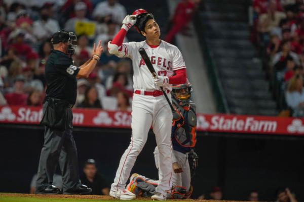 Los Angeles Angels designated hitter Shohei Ohtani takes off his helmet after swinging for a strike during the seventh inning of a baseball game against the Houston Astros in Anaheim, Calif., on July 15, 2023. (Ryan Sun/Getty Images)