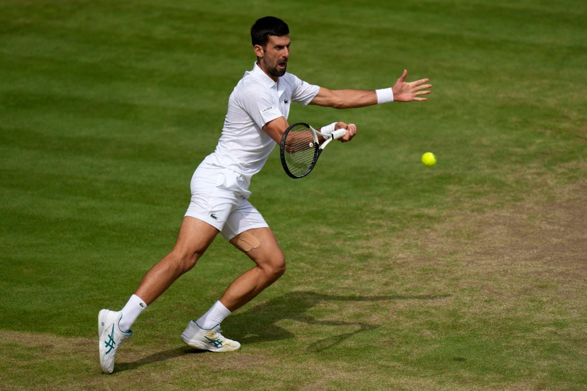 Serbia's Novak Djokovic returns to Spain's Carlos Alcaraz in the final of the men's singles on day fourteen of the Wimbledon tennis championships in London on July 16, 2023. (Alastair Grant/AP Photo)