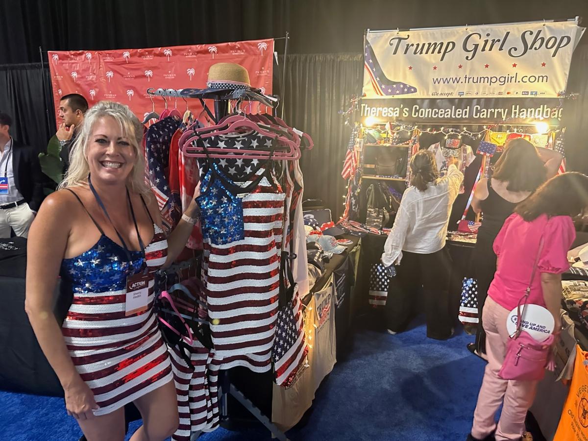  Sherry Meldin models a popular item at the Trump Girl Shop booth—a sequined, American flag dress—at the Turning Point Action Conference in West Palm Beach on July 15, 2023. (Nanette Holt/The Epoch Times)