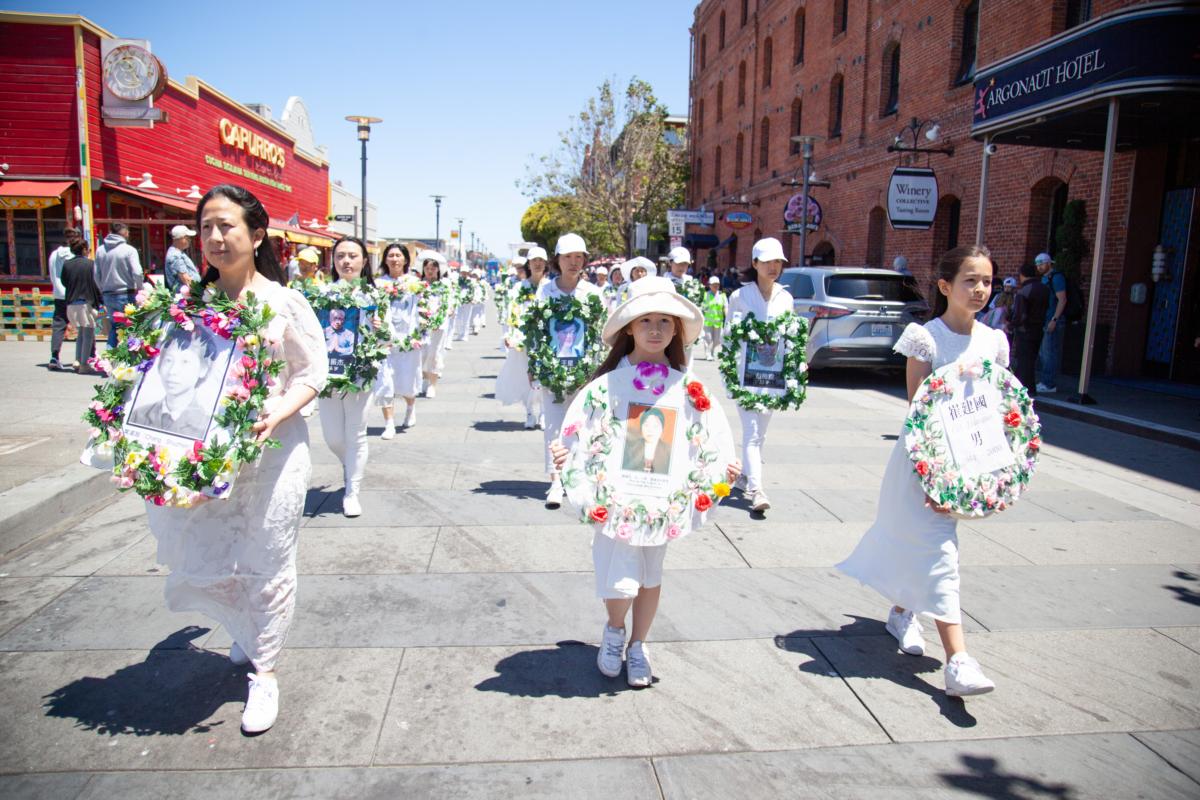 Women dressed in white commemorate people who lost their lives during the persecution of Falun Gong in China in a grand parade held in San Francisco on July 15, 2023. (Lear Zhou/The Epoch Times)