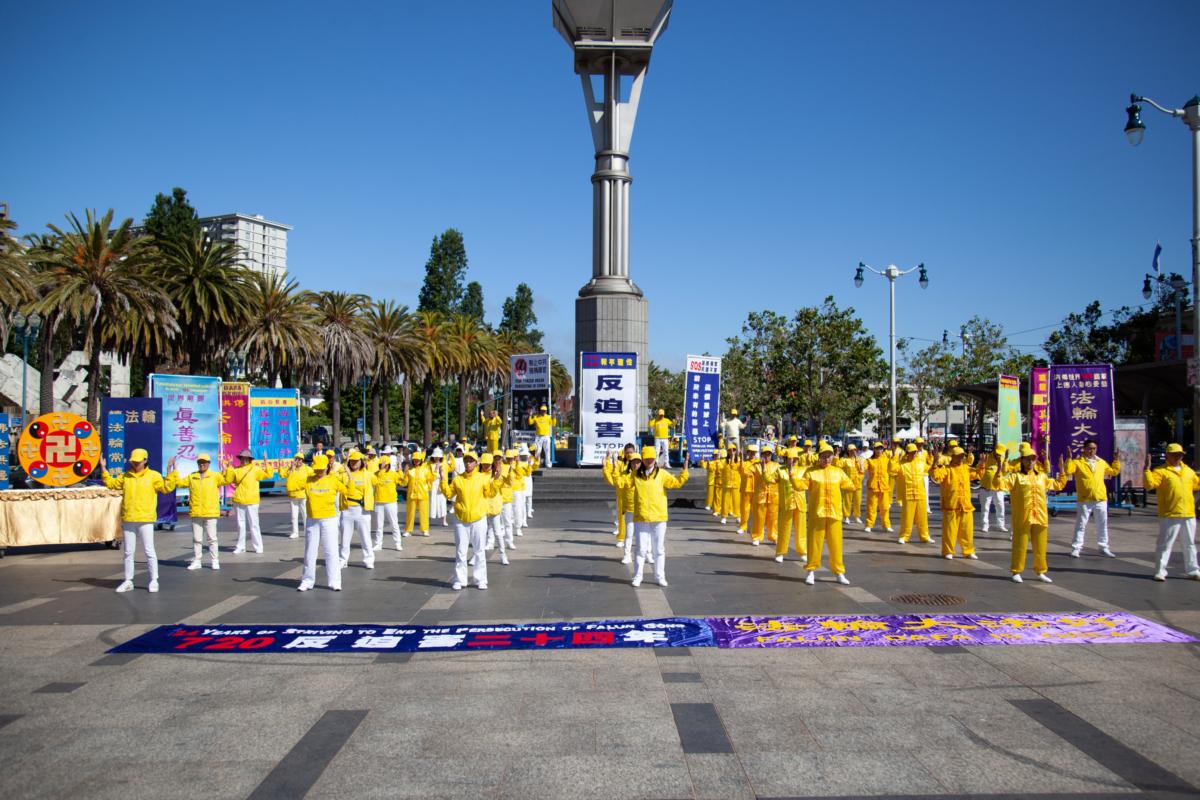 Falun Gong practitioners perform the second exercise before a rally held in San Francisco on July 15, 2023. (Lear Zhou/The Epoch Times)
