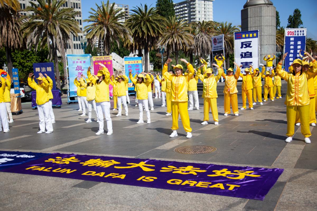 Falun Gong practitioners perform the second exercise before a rally held in San Francisco on July 15, 2023. (Lear Zhou/The Epoch Times)