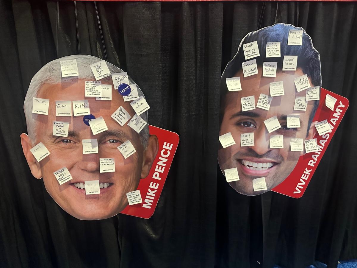  Attendees at the Turning Point Action Conference were encouraged to decorate oversized images of presidential candidates' faces—including former Vice President Mike Pence (L) and Vivek Ramaswamy—with messages at the conservative gathering in West Palm Beach, Fla., on July 16, 2023. (Nanette Holt/The Epoch Times)
