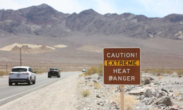 A heat advisory sign is shown along U.S. highway 190 during a heat wave in Death Valley National Park in Death Valley, Calif., on July 16, 2023. (Ronda Churchill/AFP via Getty Images)