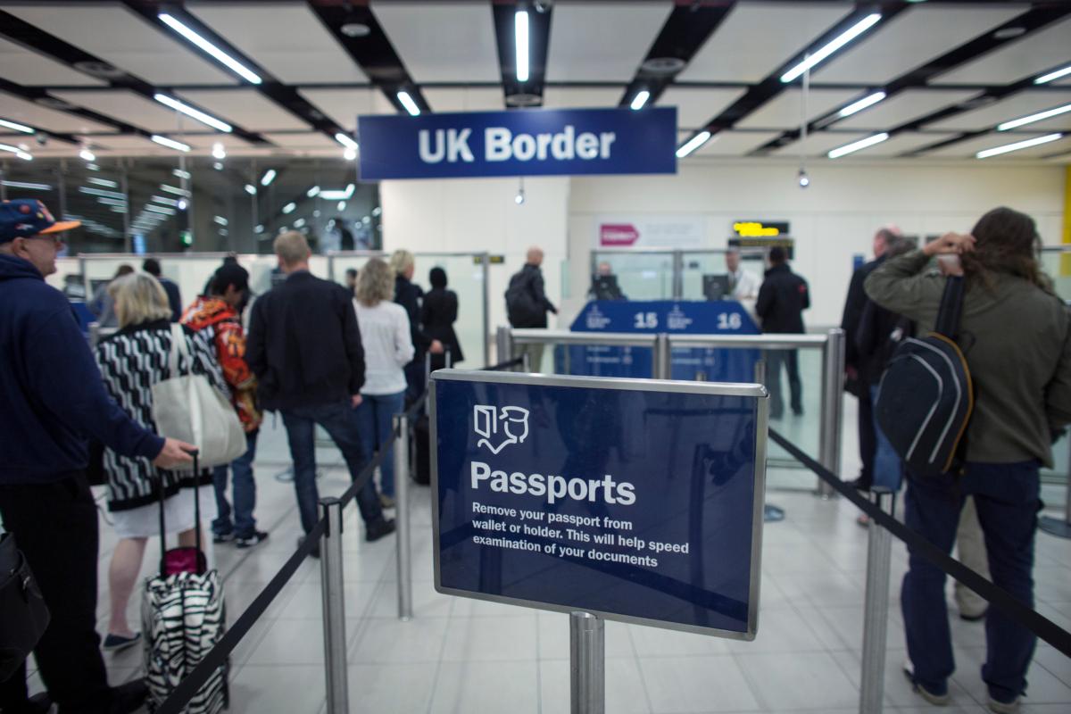 Border Force check the passports of passengers arriving at Gatwick Airport near London on May 28, 2014. (Oli Scarff/Getty Images)