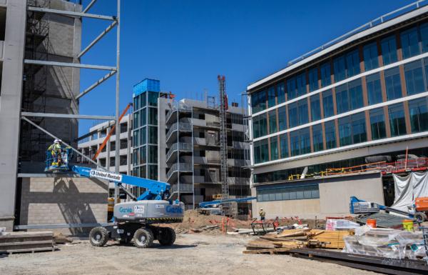Construction crew work to complete a new medical facility at the University of California–Irvine in Irvine, Calif., on July 13, 2023. (John Fredricks/The Epoch Times)
