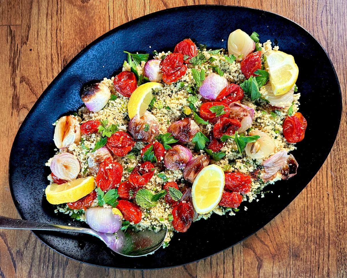 The couscous in this salad provides a bright and aromatic bed for roasted onions and tomatoes, which infuse the grains with their pan juice. (Lynda Balslev for Tastefood)