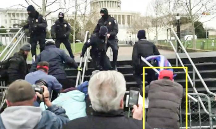 Spencer Geller (yellow box) was among protesters pushing over police barricades at the first breach on Jan. 6, 2021. (FBI/Screenshot via The Epoch Times)