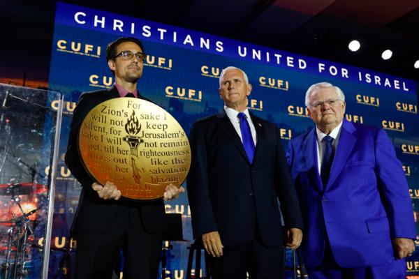 Republican presidential candidate, former Vice President Mike Pence is given the "Defender of Israel" award by the founder and National Chairman for Christians United For Israel (CUFI), evangelical pastor John Hagee (right) during the 2023 Christians United for Israel summit in Arlington, Va., on July 17, 2023. (Anna Moneymaker/Getty Images)