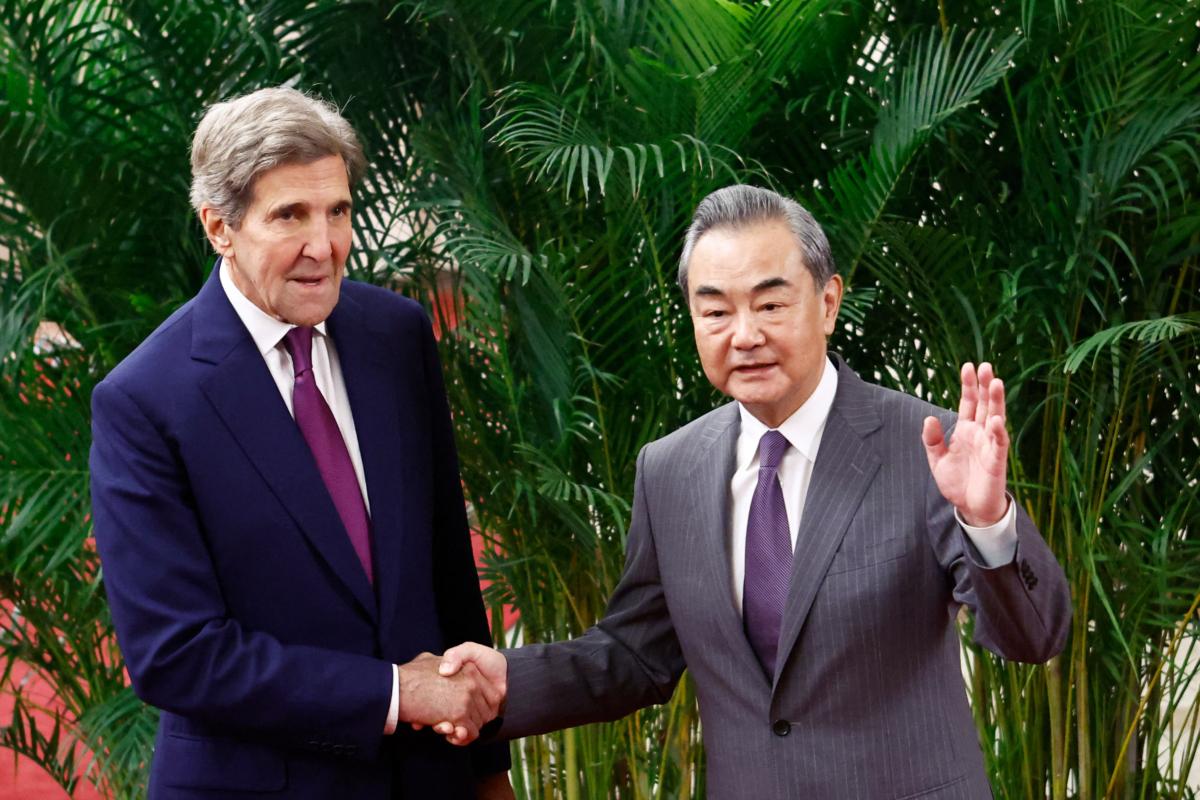U.S. Climate Envoy John Kerry and China's top diplomat Wang Yi (R) shake hands before a meeting in Beijing on July 18, 2023. (Florence Lo/Pool/AFP via Getty Images)