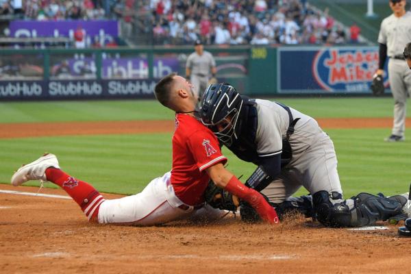 Los Angeles Angels' Zach Neto, left, collides with New York Yankees catcher Jose Trevino as he tries to score on a double by Shohei Ohtani during the third inning of a baseball game in Anaheim, Calif., on July 17, 2023 (Mark J. Terrill/AP Photo)