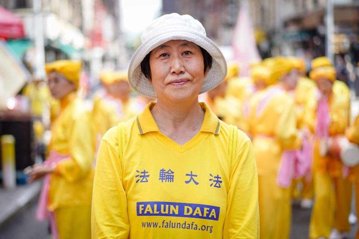 Xia Deyun takes part in a Falun Gong parade to commemorate the 24th anniversary of the persecution of the spiritual discipline in China, in New York's Chinatown on July 15, 2023. (Samira Bouaou/The Epoch Times)