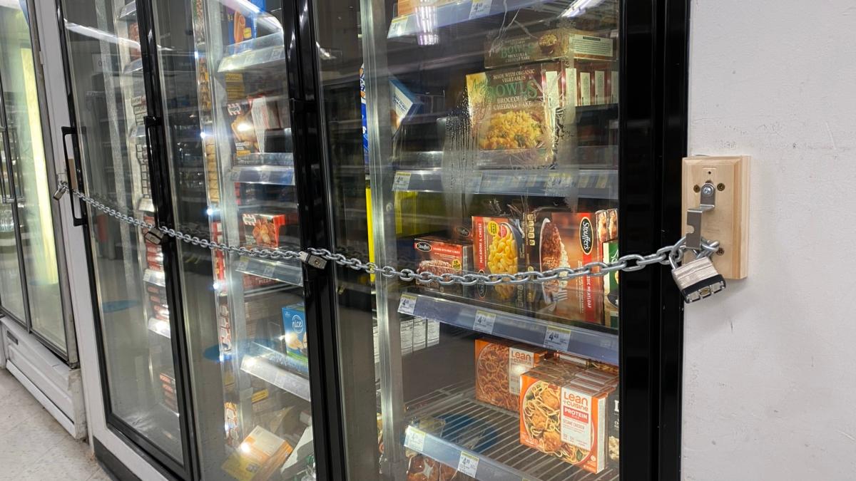 A close-up view of chains securing a freezer full of food in a Walgreens store in San Francisco, Calif. on July 18, 2023. (Lear Zhou/The Epoch Times)