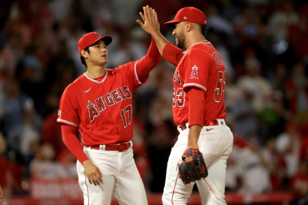 Shohei Ohtani (17) celebrates with Carlos Estevez (53) of the Los Angeles Angels after defeating the New York Yankees in a game at Angel Stadium of Anaheim in Anaheim, Calif., on July 18, 2023. (Sean M. Haffey/Getty Images)