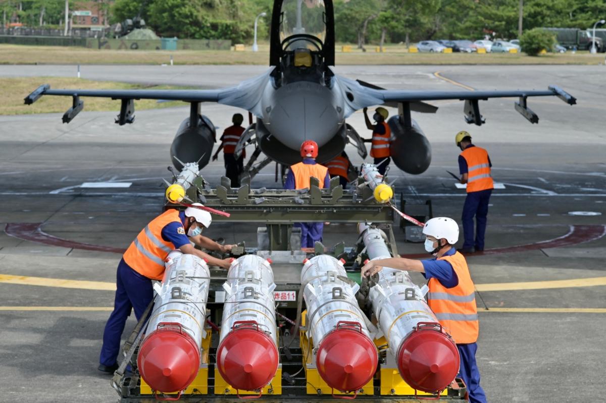 Air force soldiers prepare to load U.S. made Harpoon AGM-84 anti ship missiles in front of an F-16V fighter jet during a drill at Hualien Air Force base on Aug. 17, 2022. (Sam Yeh/AFP via Getty Images)