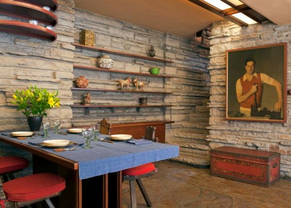 Instead of wood paneling or drywall, the backdrop to many of Fallingwater’s rooms is hand-chiseled stacked stone from a quarry near the Pennsylvania mountain site. Other important details of this room—including the living and dining rooms in an open plan—are the large portrait of the house’s owner, family patriarch Edgar Jonas Kaufmann, and Wright-designed furnishings, such as the room’s table and chairs. (Christopher Little/Courtesy of the Western Pennsylvania Conservancy)