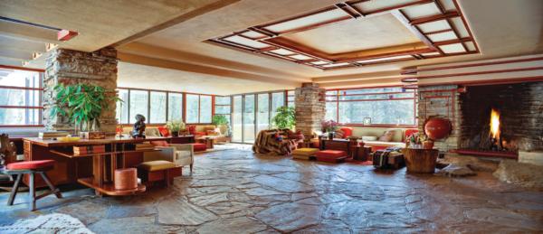 Stone walls, floors, and natural light are the defining features of this room, designed as an open-plan concept that Wright is credited with pioneering. His architectural goal with this space was to encourage gathering and functionality, as the room includes a two-sided desk, as well as spacious seating areas, with the fireplace as a centerpiece. A symmetrical ceiling design draws the eye in this airy space. (Christopher Little/Courtesy of the Western Pennsylvania Conservancy)