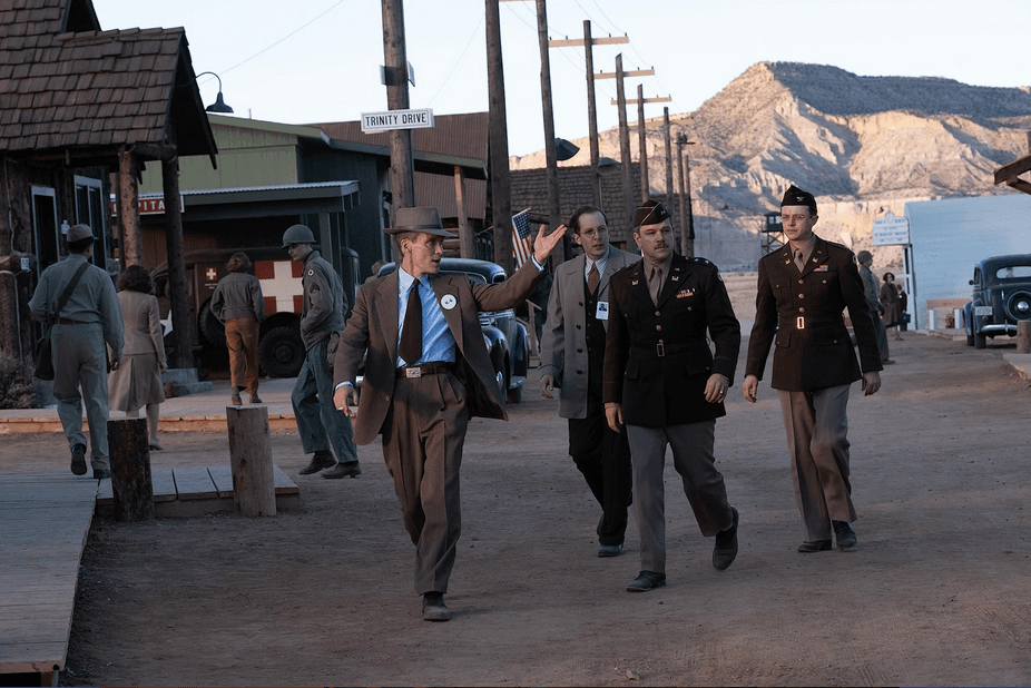 (L–R, front) J.R. Oppenheimer (Cillian Murphy), Enrico Fermi (Danny Deferrari), Lt. Gen. Leslie Groves (Matt Damon), and Kenneth Nichols (Dane DeHaan) in the town built specifically for the development of the atomic bomb, in "Oppenheimer." (Universal Pictures)