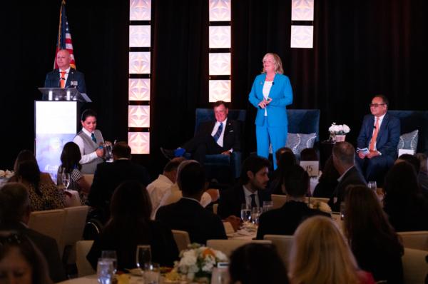 Orange County Supervisors Katrina Foley (C) and Don Wagner (L) and County Executive Officer Frank Kim (R) speak at the first Annual State of the County Luncheon in Newport Beach, Calif., on July 19, 2023. (John Fredricks/The Epoch Times)