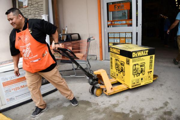 Workers help residents at Home Depot, where they are buying generator equipment and other supplies on Aug. 29, 2019, as they prepare for Hurricane Dorian. (Michele Eve Sandberg/AFP via Getty Images)