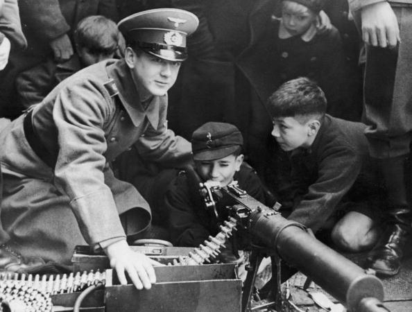 German boys are shown how to fire a machine gun, circa 1935. (FPG/Hulton Archive/Getty Images)
