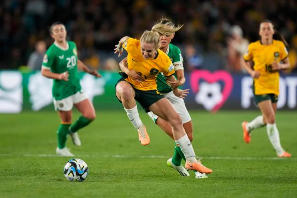 Australia's Ellie Carpenter, left, battles for the ball with Ireland's Katie McCabe during the Women's World Cup soccer game between Australia and Ireland at Stadium Australia in Sydney, Australia on July 20, 2023. (Rick Rycroft/AP Photo)