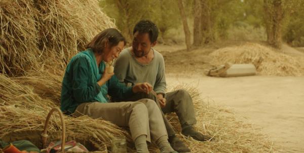 Cao Guiying (Hai Qing) and Ma Youtie (Wu Renlin) take a break from farm work, in "Return to Dust." (Hucheng No.7 Films)