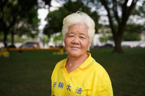 An Rongfen, a Falun Gong adherent, poses for a photo at the National Mall in Washington on July 20, 2023. (Madalina Vasiliu/The Epoch Times)