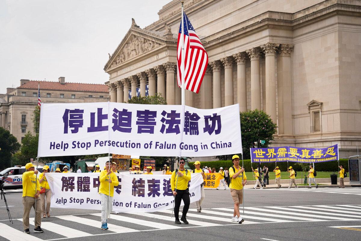 Falun Gong adherents march to mark the 24th anniversary of the Chinese regime's persecution of the spiritual discipline, in Washington on July 20, 2023. (Madalina Vasiliu/The Epoch Times)