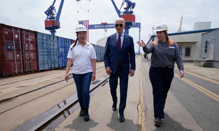 President Joe Biden tours a shipyard with Megan Heileman, Manager, PSI Apprentice Program (L) and Emily Andrewson (R), apprentice welder, in Philadelphia, Thursday, July 20, 2023. (AP Photo/Susan Walsh)