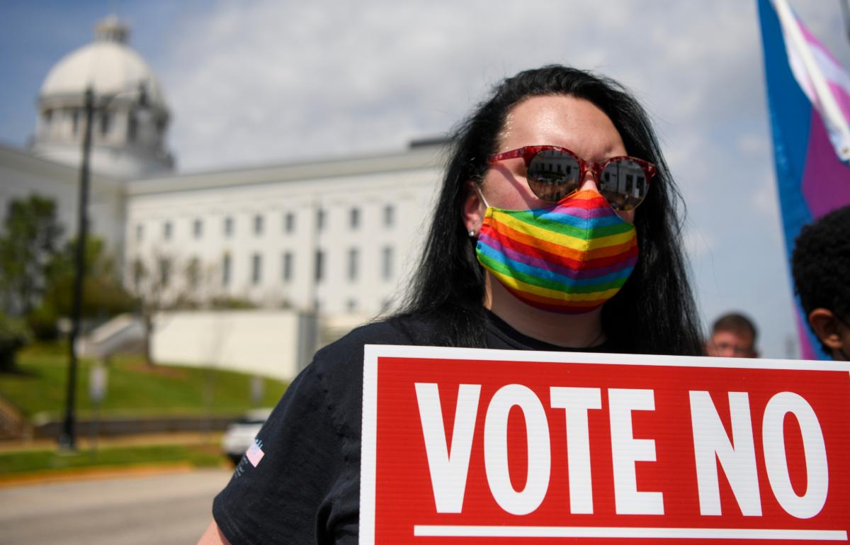 A demonstrator holds a sign during a rally at the Alabama State House to draw attention to legislation on transgender issues introduced in Alabama in Montgomery, Alabama, on March 30, 2021. (Julie Bennett/Getty Images)