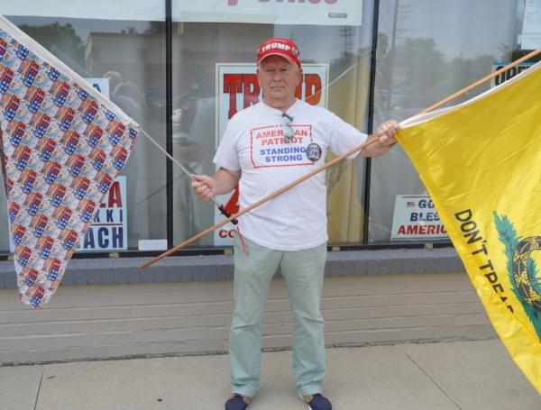 A grassroots activist protesting the indictment of 16 Michigan GOP electors outside of a press conference in Macomb County, Mich. on July 19, 2023. (Steven Kovac/Epoch Times)
