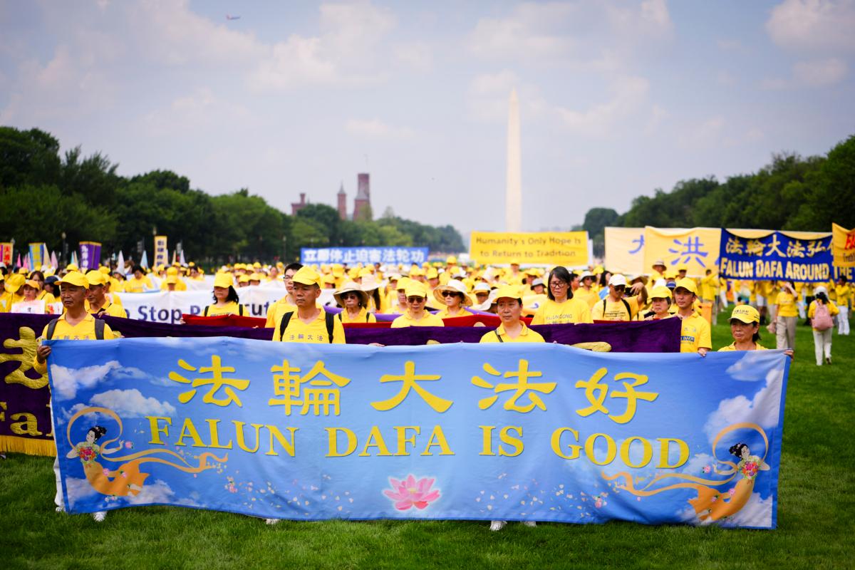 Falun Gong practitioners take part in a parade to mark the 24th anniversary of the persecution of the spiritual discipline in China by the Chinese Communist Party in Washington on July 20, 2023. (Madalina Vasiliu/The Epoch Times)