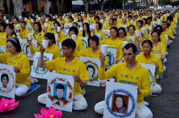 Falun Gong adherents hold a candlelight vigil in front of the Chinese Consulate to mark 24 years of persecution by the Chinese Communist Party in Los Angeles on July 18, 2023. (Alex Lee/The Epoch Times)