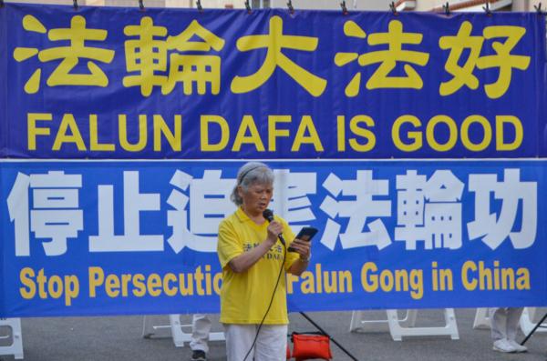 Lei Yingqun, a local Falun Gong practitioner, speaks at a candlelight vigil in front of the Chinese Consulate in Los Angeles on July 18, 2023. (Alex Lee/The Epoch Times)