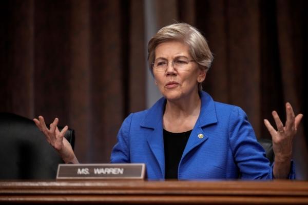 Sen. Elizabeth Warren (D-Mass.) speaks to a staff member before the start of a Senate Banking Committee hearing on oversight of credit reporting agencies on Capitol Hill in Washington on April 27, 2023. (Drew Angerer/Getty Images)