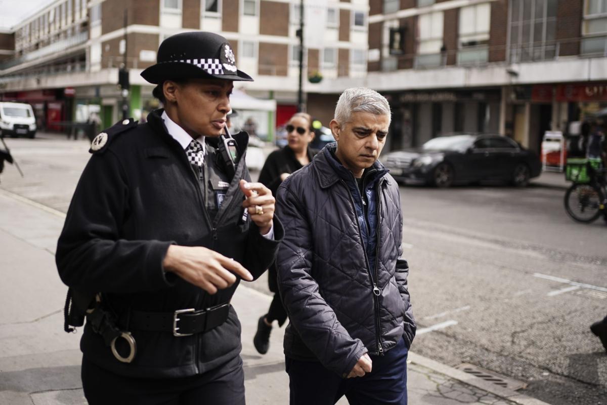 The mayor of London, Sadiq Khan, listens to Commander Alison Heydari of the Metropolitan Police during a visit to an estate in Edgware Road, Westminster, central London, to discuss Operation Nightingale, on April 14, 2023. (PA)
