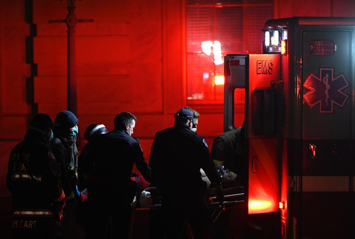 Paramedics put Rosanne Boyland in a DC Fire and EMS Department ambulance at the U.S. Capitol after performing cardiopulmonary resuscitation on January 6, 2021. (Andrew Caballero-Reynolds/AFP via Getty Images)