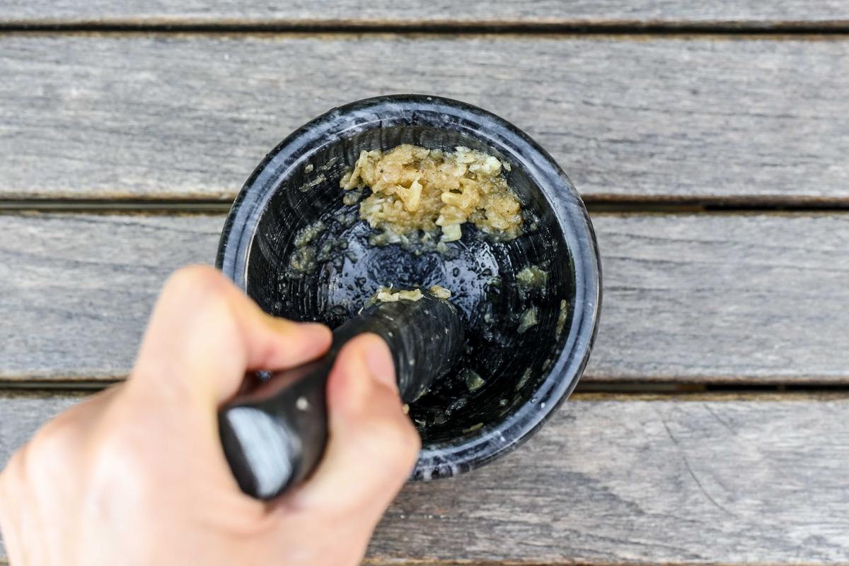 According to Provençal tradition, an aïoli should be prepared using a mortar and pestle to crush the garlic cloves and emulsify the olive oil mixture. (Audrey Le Goff)