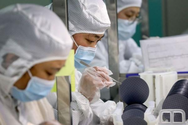 Employees make chips at a factory of Jiejie Semiconductor Co. in Nantong, Jiangsu Province, China, on March 17, 2021. (PSTR/AFP via Getty Images)