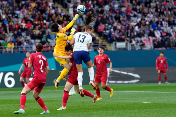 Vietnam's goalkeeper Thi Kim Thanh Tran (14) punches the ball away from United States' Alex Morgan (13) during the Women's World Cup Group E soccer match between the United States and Vietnam at Eden Park in Auckland, New Zealand on July 22, 2023. (Abbie Parr/AP Photo)