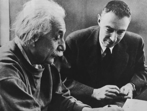 Physicists Albert Einstein (L) and Oppenheimer conferring, circa 1950. Image courtesy of US Govt. Defense Threat Reduction Agency. (Public Domain)