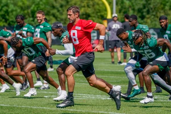 New York Jets quarterback Aaron Rodgers (8) warms up during practice at the NFL football team's training facility in Florham Park, N.J., on July 21, 2023. (John Minchillo/AP Photo)