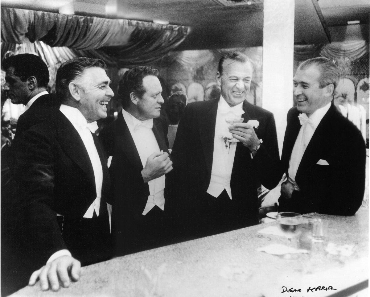 (L to R) Actors Clark Gable, Van Heflin, Gary Cooper, and James Stewart enjoy a laugh during a New Year’s party held at Romanoff’s restaurant in Beverly Hills, Calif. (SSLIM AARONS ESTATE/Getty Images)