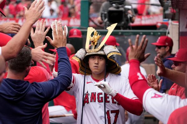 Los Angeles Angels' Shohei Ohtani is congratulated by teammates in the dugout after hitting a solo home run during the first inning of a baseball game against the Pittsburgh Pirates in Anaheim, Calif., on July 23, 2023 (Mark J. Terrill/AP Photo)